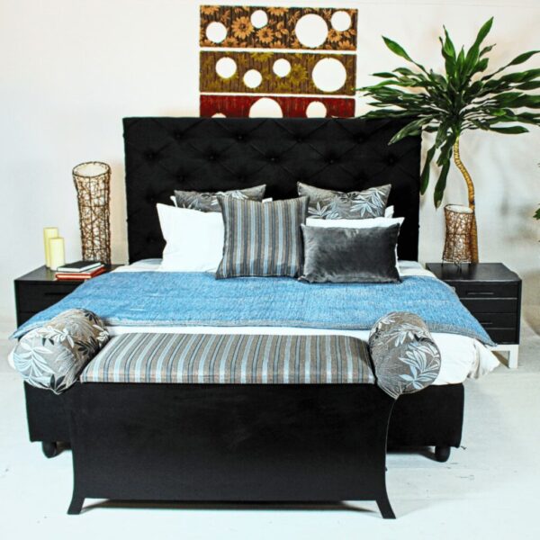fully padded upholstered bed with a high headboard