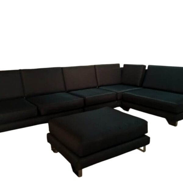 Black L-shaped sectional sofa with matching ottoman